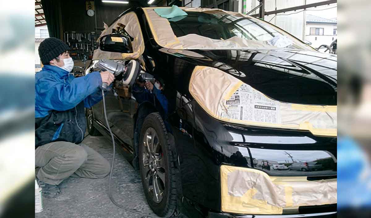 コーティング作業風景です。コーティングしない部分をマスキングし、車体全部をポリッシャーで磨きます。その後、シリコンで脱脂します。 